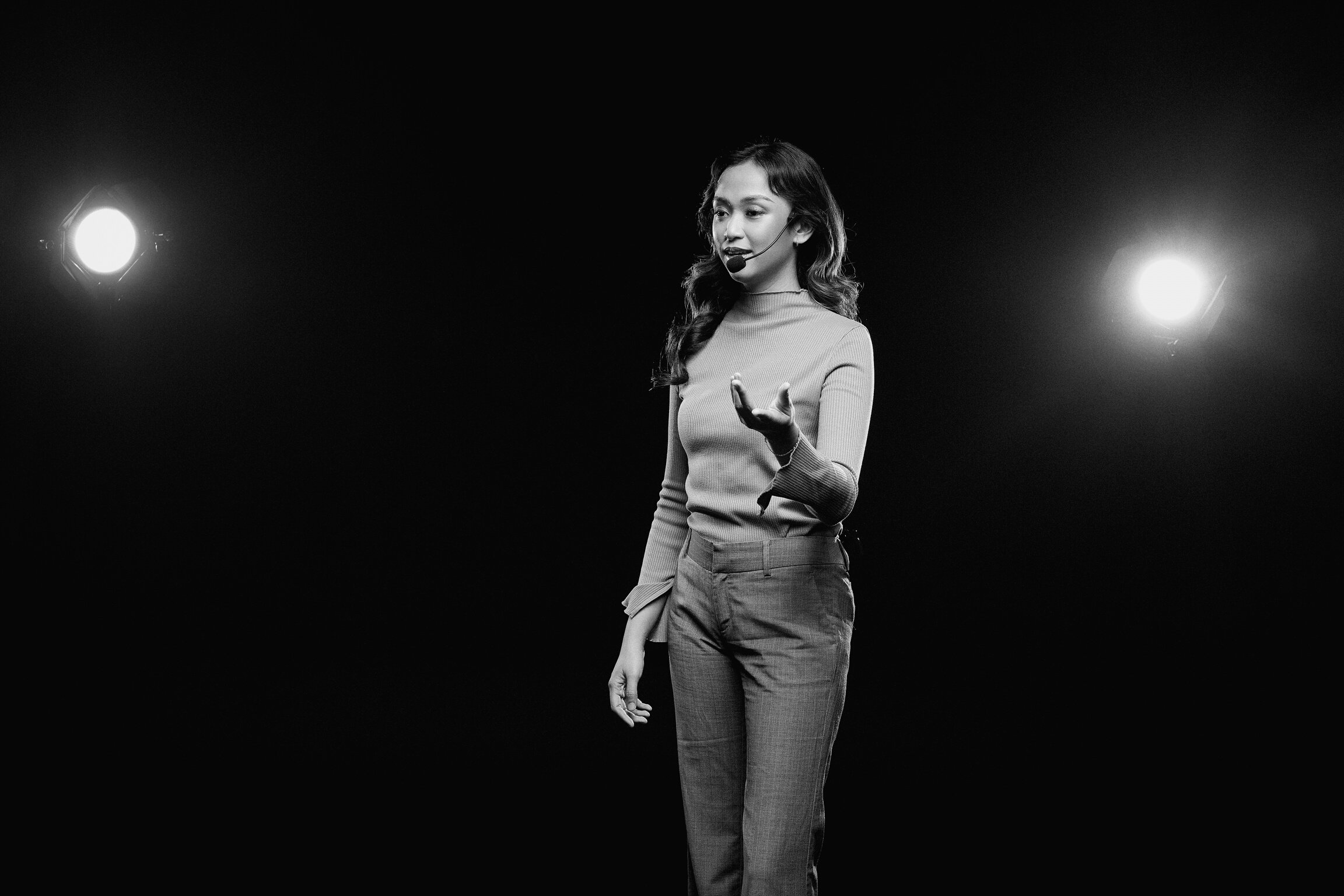 Woman Giving a Talk in Public on Stage